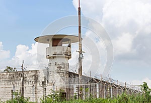 Old prison guard tower or watchtower with security systems barbed wire fence