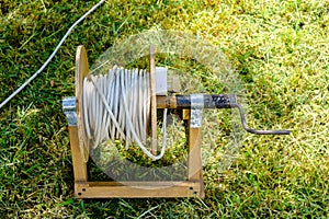 Old prolongation electric cable on green grass in the park photo