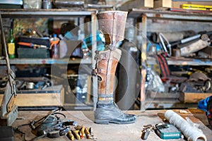 old prosthetic leg displayed on workshop table