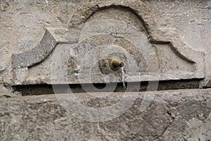 Old public marble fontain with water photo