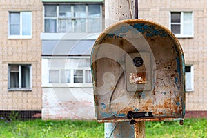 Old public russian wired urban telephone post - useless abandoned and broken.