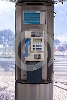 An old public telephone box located in the town of Funchal Madeira Island in Portugal on the public street on a sunny summers day