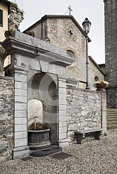 Old public water fountain in Italy
