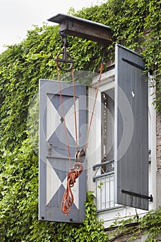 Old pulley on an apartment building