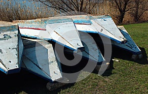 Old punt boats lay upside down on a shore