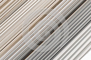 Old PVC plastic panels in a pile of building used recycling construction material. Texture background with lines and stripes