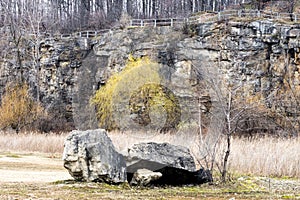 An old quarry restored and turned into a wilderness park, landscape with large boulders and trees