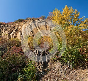 Old quarry. Rocks and yellow trees