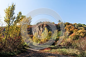 Old quarry. Rocks and yellow trees