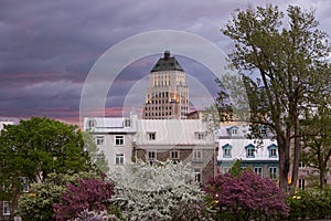 Old Quebec buildings seen from the top of its walls during an early spring morning with a dramatic stormy sky