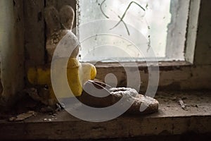 Old rabbit toy and shoe in the kindergarten at the abandoned village Kopachi near Chernobyl