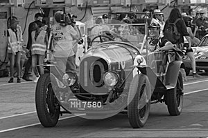 Old racing car and spectators