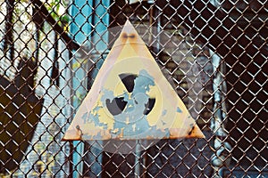 Old radiation sign on wire fence in Chernobyl Exclusion Zone, Ukraine