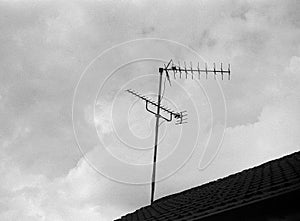 Old radio and television antenna on a house roof