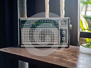 An old radio on a wooden table