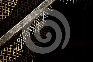 Old ragged rusty wire mesh fence