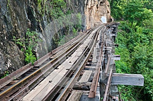Old rail beside cliff and river
