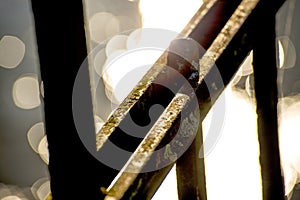 Old railing in a port with backlit reflexions