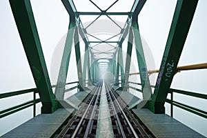 Old railroad bridge in fog