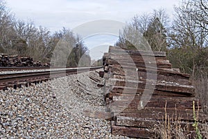 Old railroad ties in a stack by the tracks