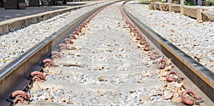 Old railroad tracks at a train station close up background