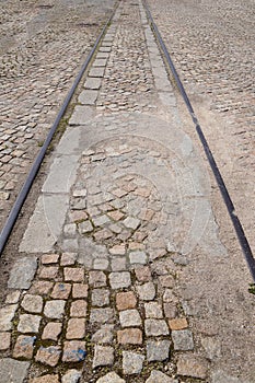 old rails in pavement stone paving for vertical vintage background