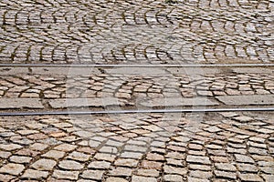 old rails in pavement stone paving for vintage background