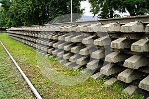 Old rails and sleepers. The rails and sleepers are stacked on each other. Renovation of the railway