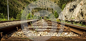 Old railtracks with a tunnel ahead