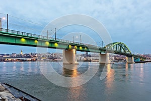 Old railway bridge across the Sava River at dusk