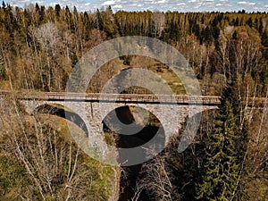 Old railway bridge in the forest. The view from the top. Spring.