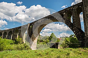 Old railway bridge, old viaduct Vorohta, Ukraine. Carpathian Mountains, wild mountain landscape.
