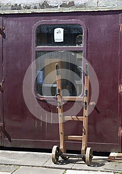 Old railway carriage with vintage luggage trolley