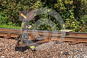 Old railway cross switch covered with black oil and dirt. Rail t