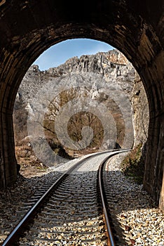 Old railway passing through short tunnels