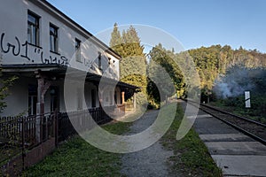 An old railway station with a painted building at the railroad