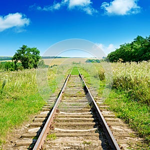 Old railway track among fields