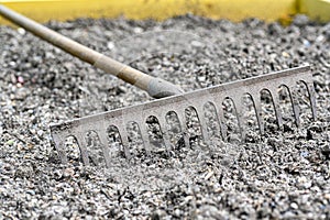 old rake lying in cultivation box in garden