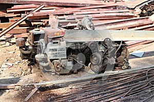 The old rebar has rust and the old engine collapses on the vintage background. photo