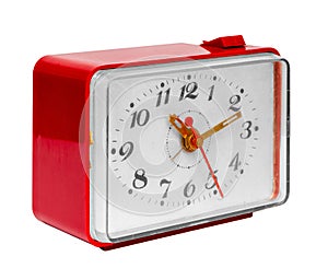 Old red alarm clock on a white background