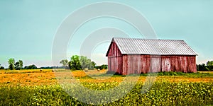 Old red barn in a field with aqua blue sky
