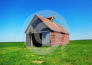 Old Red Barn in Green Field