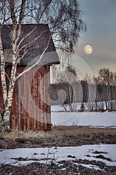 Old red barn in wintry landscape