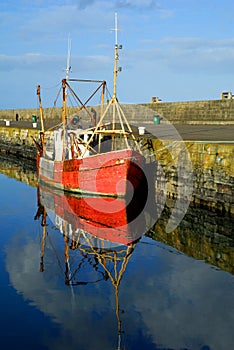 Old red boat in Howth Harbor, Dublin, Ireland