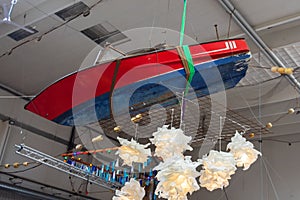 An old red boat suspended from the ceiling. Interior decoration