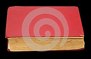 Old red book on a black background