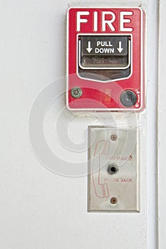 Old red box of fire alarm on white wall background