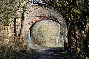 Old red brick bridge over disused railway line