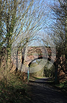 Old red brick bridge over disused railway line