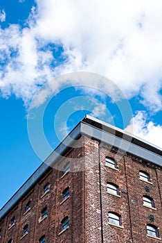 Old red brick building or factory with many small windows